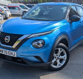 Blue Nissan Juke 1.0 DIG-T Acenta SUV, close-up front view showing grille and alloy wheel - 313 Motors, Oldham
