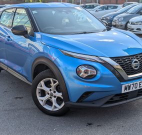 Blue Nissan Juke 1.0 DIG-T Acenta SUV parked in dealer forecourt, front three-quarter view - 313 Motors, Oldham